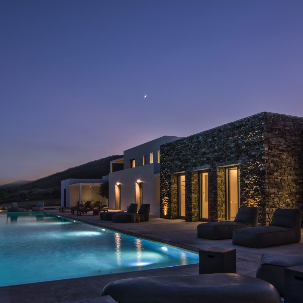 A serene villa swimming pool surrounded by palm trees, perfect for a relaxing holiday